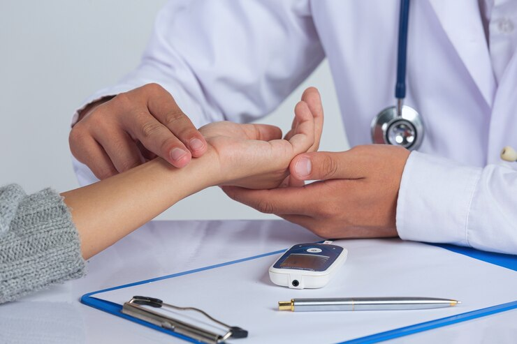 Doctor checking the pulse at the left hand wrist